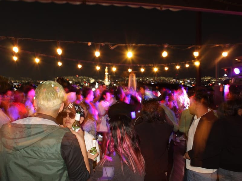 Evento en terraza con vista nocturna de la ciudad